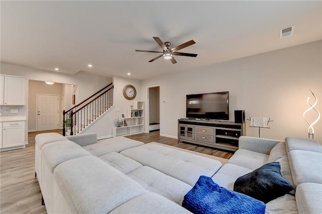 5452 Fountainhead Ln, Auburn, GA 30011 - living room with ceiling fan, light wood finished floors, stairs, and visible vents