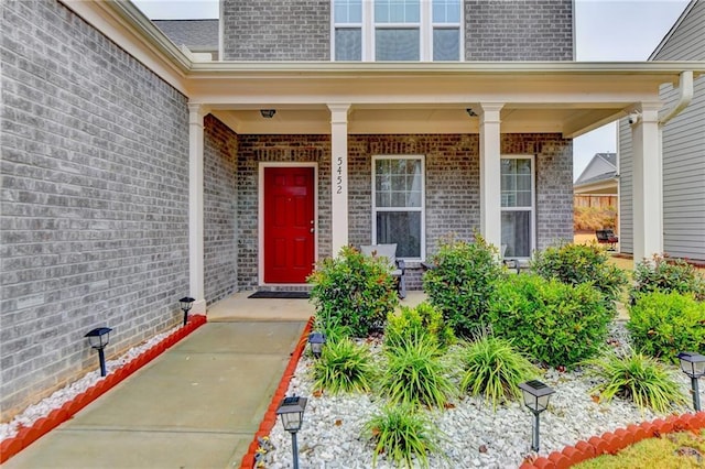 5452 Fountainhead Ln, Auburn, GA 30011 - doorway to property featuring brick siding and a porch