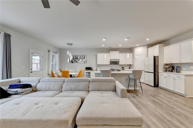 5452 Fountainhead Ln, Auburn, GA 30011 - living area with light wood-style floors, recessed lighting, and ceiling fan with notable chandelier