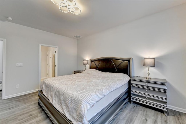 5452 Fountainhead Ln, Auburn, GA 30011 - bedroom featuring baseboards, wood finished floors, and visible vents