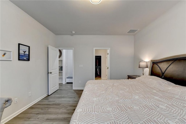 5452 Fountainhead Ln, Auburn, GA 30011 - bedroom with baseboards, wood finished floors, and visible vents