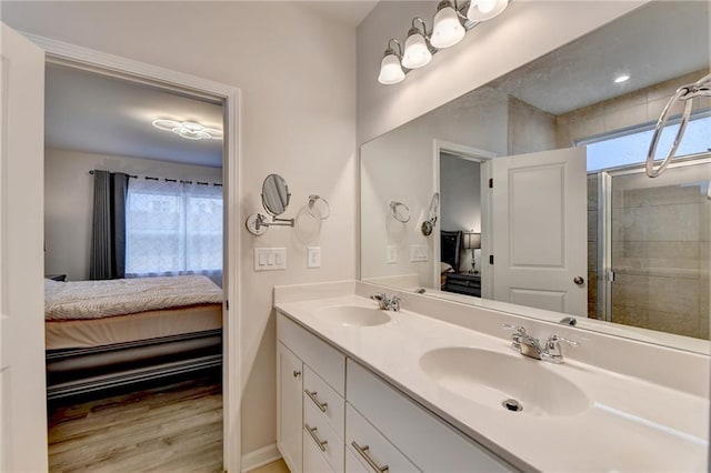 5452 Fountainhead Ln, Auburn, GA 30011 - ensuite bathroom with double vanity, a sink, connected bathroom, and wood finished floors