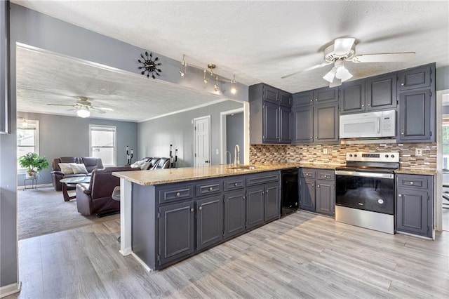 1433 Janice Ct SW, Lilburn, GA 30047 - kitchen with white microwave, stainless steel range with electric stovetop, ceiling fan, a textured ceiling, and a peninsula