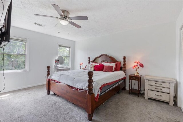 1433 Janice Ct SW, Lilburn, GA 30047 - carpeted bedroom featuring a textured ceiling and ceiling fan