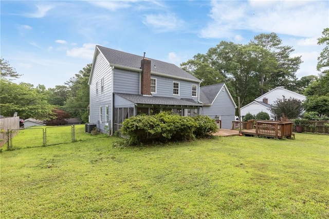 1433 Janice Ct SW, Lilburn, GA 30047 - back of house with a fenced backyard, roof with shingles, a deck, a sunroom, and a chimney