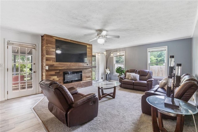 1433 Janice Ct SW, Lilburn, GA 30047 - living room featuring ceiling fan, a brick fireplace, a textured ceiling, and wood finished floors