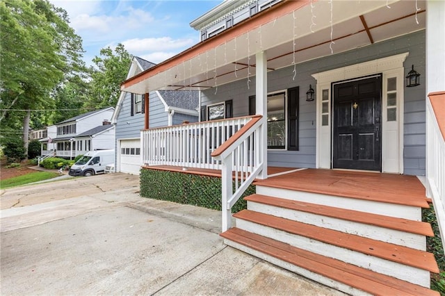 1433 Janice Ct SW, Lilburn, GA 30047 - entrance to property with covered porch, driveway, and a garage