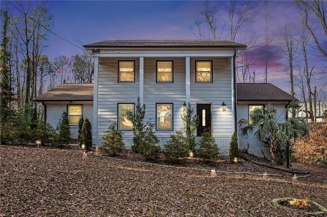 greek revival inspired property featuring brick siding