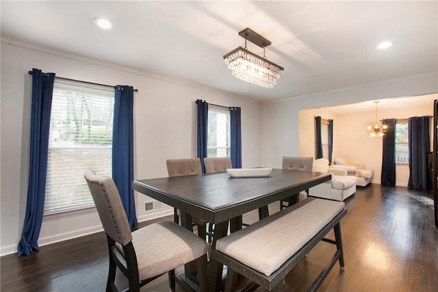 dining room with dark wood-style flooring, crown molding, recessed lighting, an inviting chandelier, and baseboards