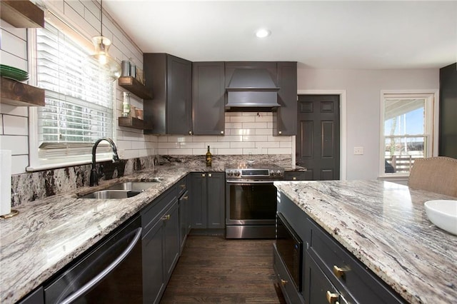 kitchen with tasteful backsplash, custom range hood, appliances with stainless steel finishes, open shelves, and a sink