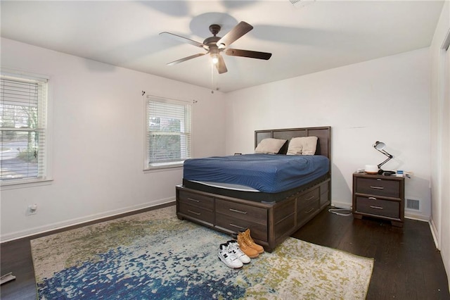 bedroom with baseboards and wood finished floors