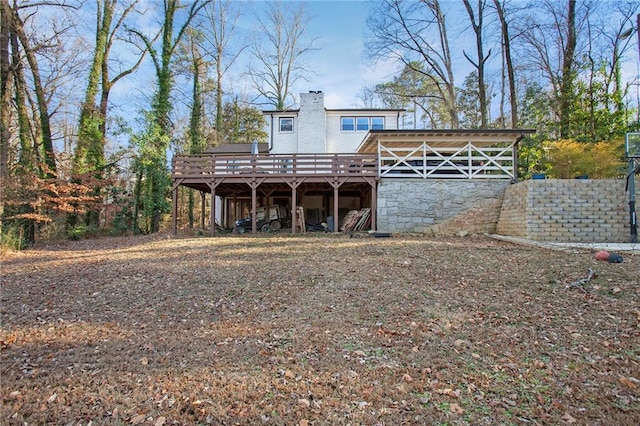 back of house featuring a chimney and a deck