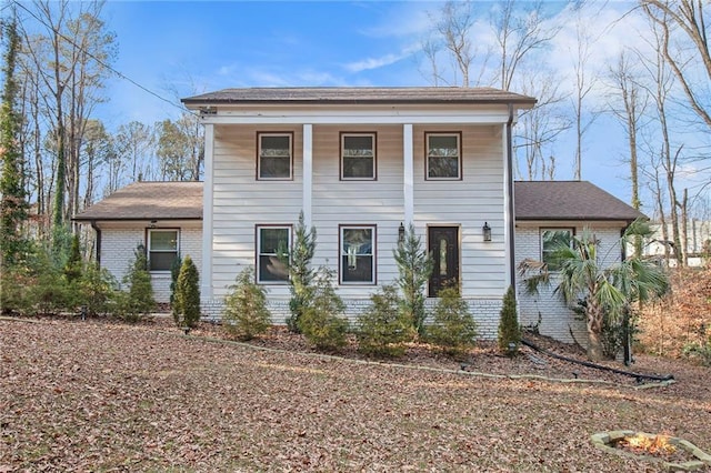 greek revival inspired property featuring brick siding