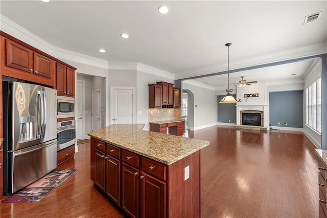 4677 Prater Way SE, Smyrna, GA 30080 - kitchen with appliances with stainless steel finishes, a center island, recessed lighting, ceiling fan, and light stone counters