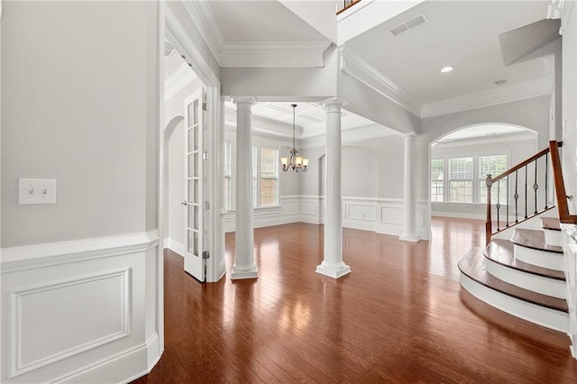 4677 Prater Way SE, Smyrna, GA 30080 - entrance foyer with ornate columns, a decorative wall, wood finished floors, stairs, and a chandelier