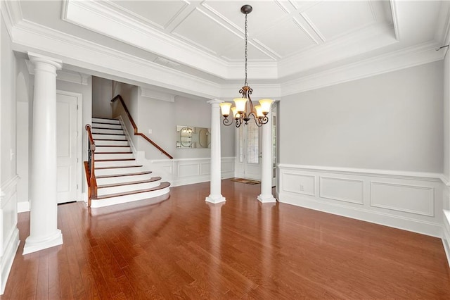 4677 Prater Way SE, Smyrna, GA 30080 - unfurnished dining area featuring decorative columns, wood finished floors, stairs, wainscoting, and a chandelier
