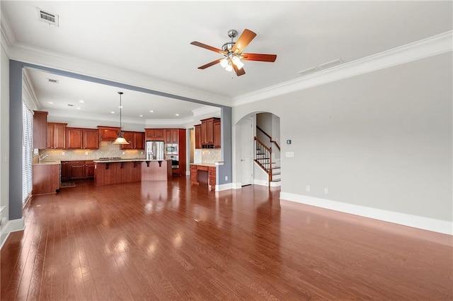 4677 Prater Way SE, Smyrna, GA 30080 - unfurnished living room with arched walkways, a ceiling fan, dark wood-style floors, stairway, and crown molding