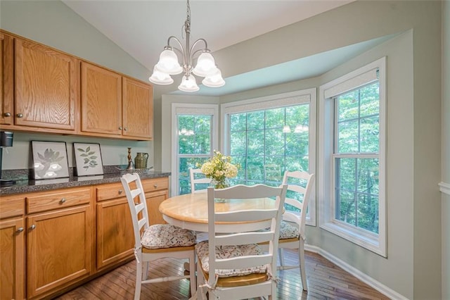 115 Oak Crest Ln, Dallas, GA 30132 - dining space with plenty of natural light, dark wood-type flooring, a chandelier, lofted ceiling, and baseboards