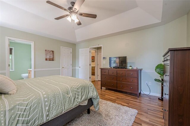 115 Oak Crest Ln, Dallas, GA 30132 - bedroom with a tray ceiling, wood finished floors, baseboards, ensuite bathroom, and ceiling fan