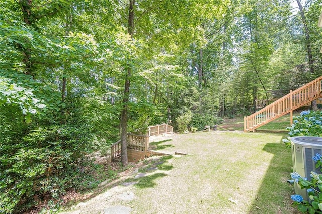 115 Oak Crest Ln, Dallas, GA 30132 - view of grassy yard featuring stairway, central air condition unit, and a wooded view