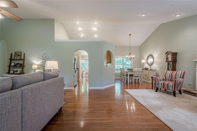115 Oak Crest Ln, Dallas, GA 30132 - living area featuring arched walkways, lofted ceiling, wood finished floors, a chandelier, and ceiling fan