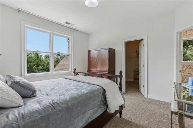 7540 Shadburn Ferry Rd, Cumming, GA 30041 - carpeted bedroom featuring a spacious closet and baseboards
