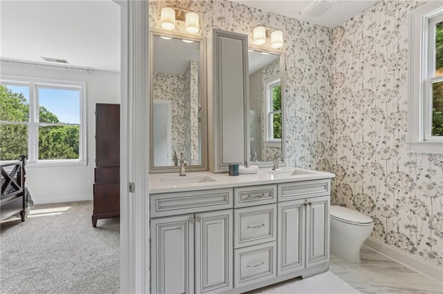 7540 Shadburn Ferry Rd, Cumming, GA 30041 - bathroom with wallpapered walls, plenty of natural light, baseboards, double vanity, and toilet