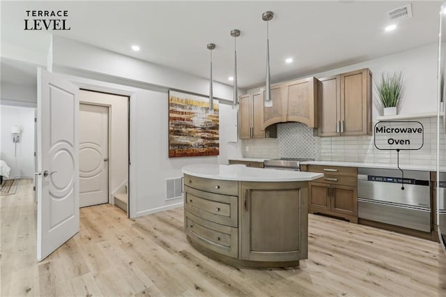 7540 Shadburn Ferry Rd, Cumming, GA 30041 - kitchen featuring light countertops, light wood finished floors, backsplash, a kitchen island, and decorative light fixtures