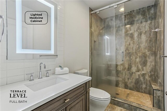 7540 Shadburn Ferry Rd, Cumming, GA 30041 - full bath featuring a stall shower, decorative backsplash, toilet, and vanity