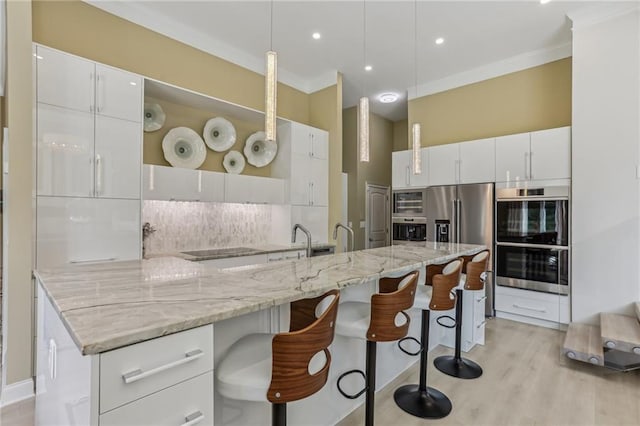 7540 Shadburn Ferry Rd, Cumming, GA 30041 - kitchen with appliances with stainless steel finishes, decorative backsplash, a breakfast bar, white cabinetry, and modern cabinets