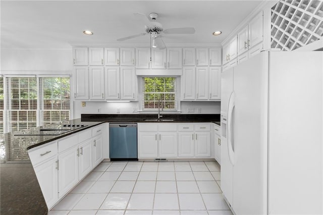 kitchen with stainless steel dishwasher, sink, light tile patterned floors, white refrigerator with ice dispenser, and ceiling fan