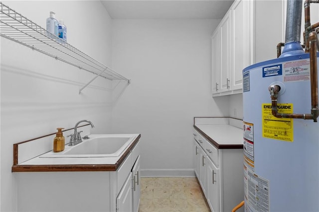 clothes washing area featuring sink, water heater, and light tile patterned flooring