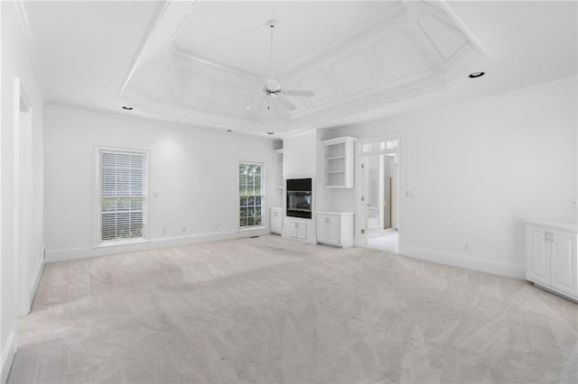 unfurnished living room featuring ceiling fan, a raised ceiling, and light colored carpet