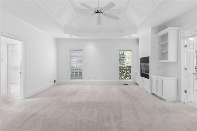 unfurnished living room featuring ceiling fan, ornamental molding, and light carpet