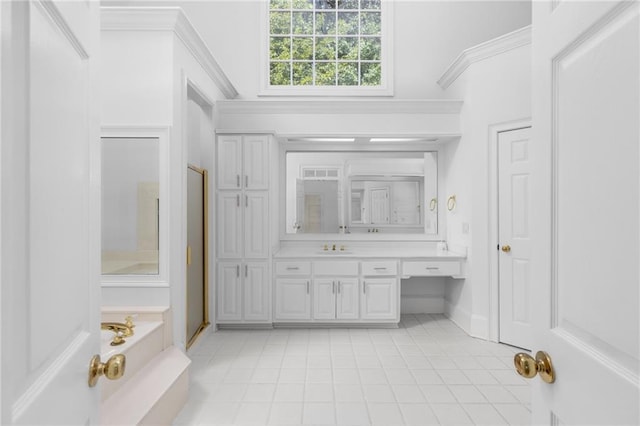 bathroom featuring tile patterned flooring, independent shower and bath, ornamental molding, and vanity