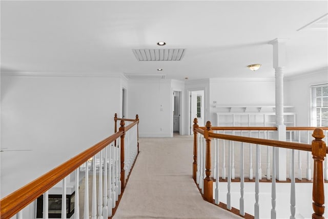hall featuring ornamental molding and light colored carpet