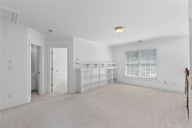 unfurnished room featuring crown molding and light colored carpet