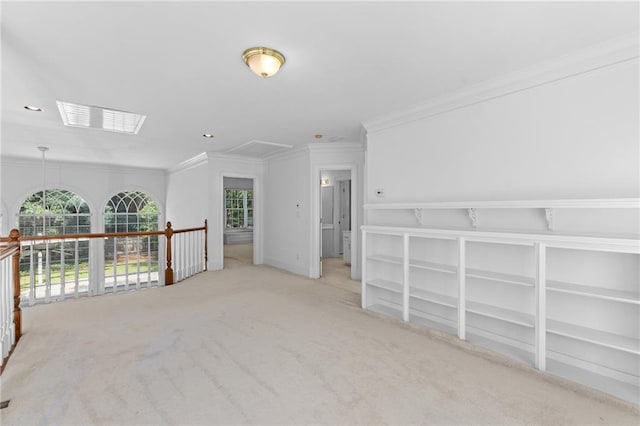 spare room featuring ornamental molding and light carpet