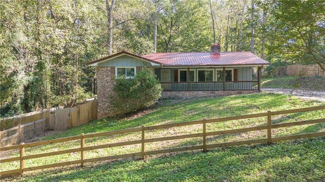 ranch-style house with covered porch and a front lawn