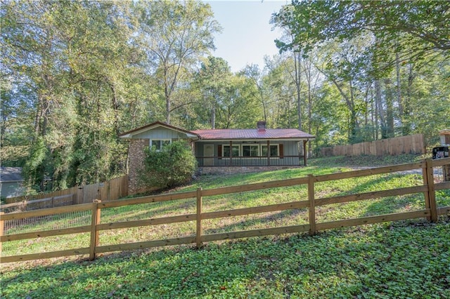 ranch-style house with covered porch and a front lawn