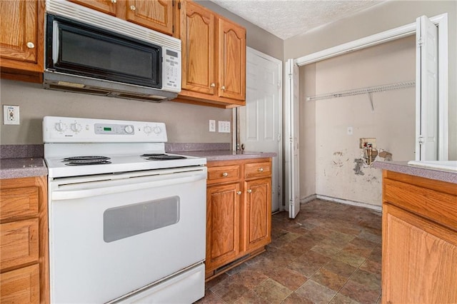 kitchen with white range with electric stovetop and a textured ceiling