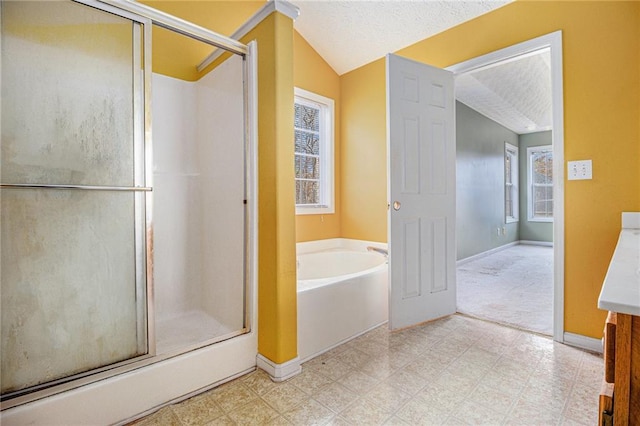 bathroom featuring vanity, separate shower and tub, a textured ceiling, and vaulted ceiling