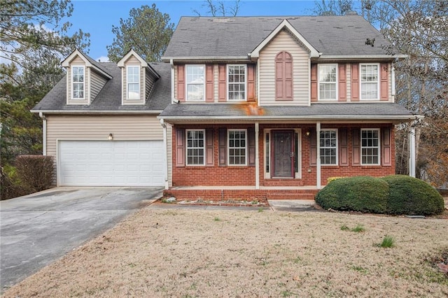 colonial inspired home featuring a garage and covered porch