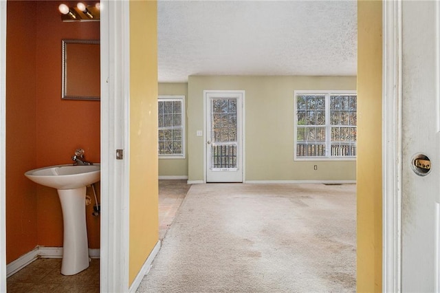 interior space featuring a textured ceiling and sink