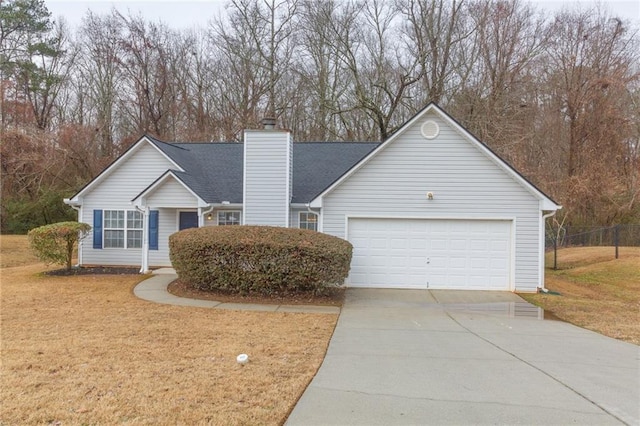 view of front of house featuring a garage and a front lawn