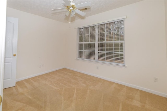 carpeted spare room with ceiling fan and a textured ceiling