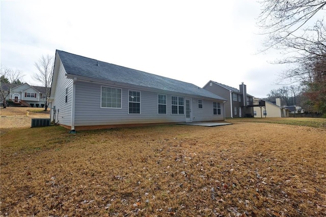 back of property with a lawn and a patio area