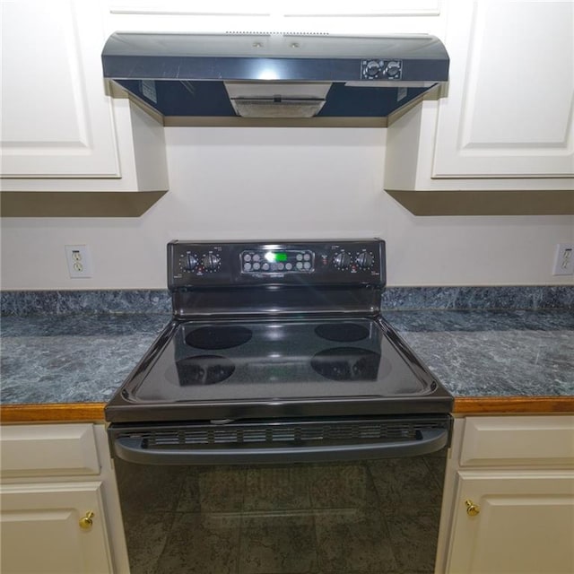 kitchen featuring black / electric stove, exhaust hood, and white cabinets