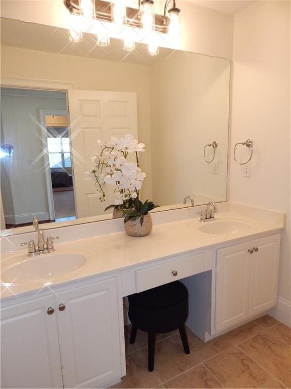 bathroom with tile patterned flooring, a sink, and double vanity