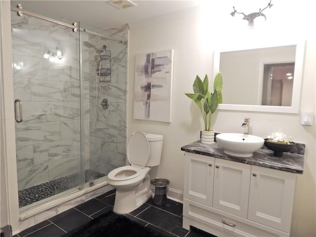 bathroom with toilet, visible vents, vanity, baseboards, and a stall shower